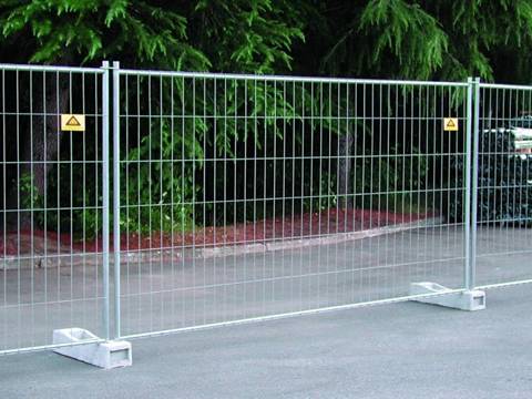La barrière portative de l'Australie est installée dans la rue derrière un parc.